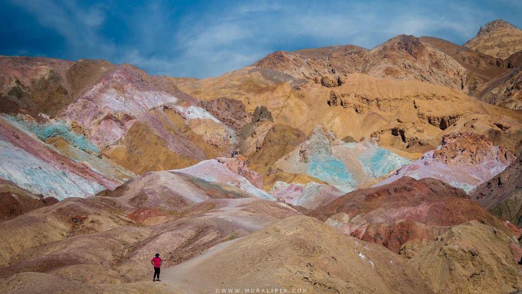 A hiker with a red shirt at Artists Palette in Death Valley National Park